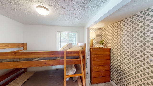 213 Devonshire Dr, Prudenville, MI 48651 - bedroom with a textured ceiling and wallpapered walls