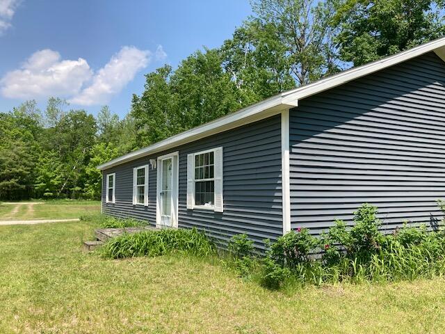 2966 Mitchell Dr, Cheboygan, MI 49721 - view of property exterior featuring a yard