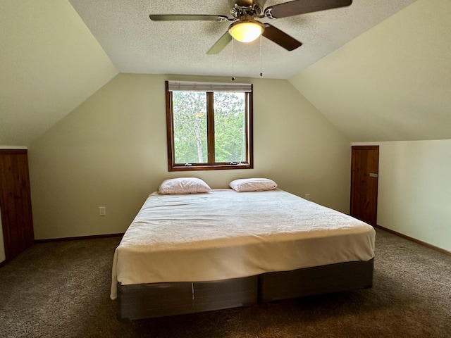 7984 US-23, Cheboygan, MI 49721 - carpeted bedroom featuring vaulted ceiling, ceiling fan, and a textured ceiling