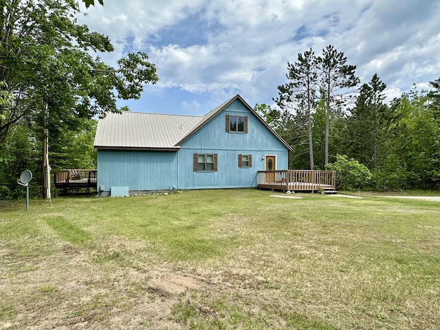 7984 US-23, Cheboygan, MI 49721 - back of property with a wooden deck, a yard, and a metal roof