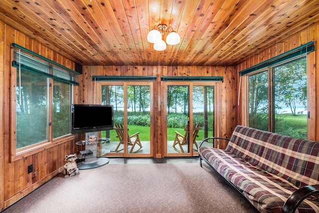 451 Gower Ln, Cheboygan, MI 49721 - living room featuring wood walls, wooden ceiling, and a chandelier