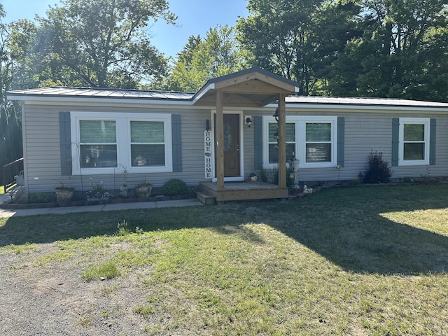 1632 Lakeview Dr, Alpena, MI 49707 - manufactured / mobile home with a front yard and a metal roof