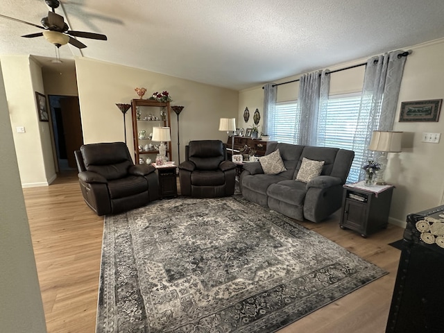 1632 Lakeview Dr, Alpena, MI 49707 - living room with light wood-type flooring, ceiling fan, and a textured ceiling