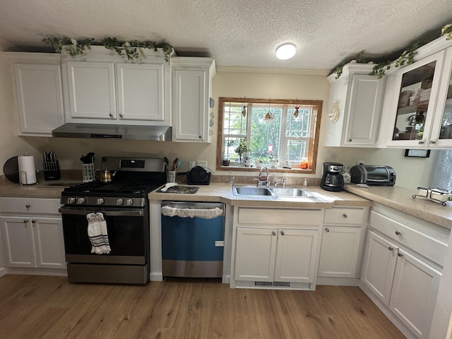1632 Lakeview Dr, Alpena, MI 49707 - kitchen with stainless steel gas range oven, dishwasher, under cabinet range hood, white cabinets, and a textured ceiling