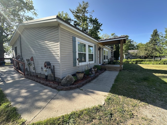 1632 Lakeview Dr, Alpena, MI 49707 - view of side of property featuring a yard