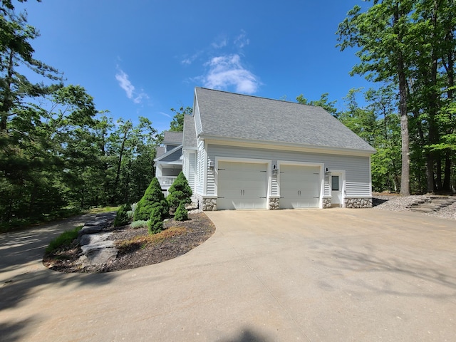 5825 Arawak Pass, Gaylord, MI 49735 - view of side of property featuring a garage and roof with shingles