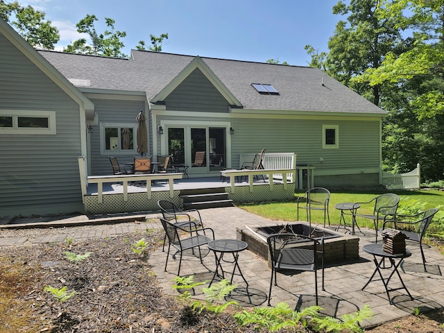 5825 Arawak Pass, Gaylord, MI 49735 - rear view of property with an outdoor fire pit, a deck, roof with shingles, and a patio area