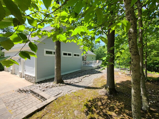 5825 Arawak Pass, Gaylord, MI 49735 - view of property exterior featuring a garage and a wooden deck