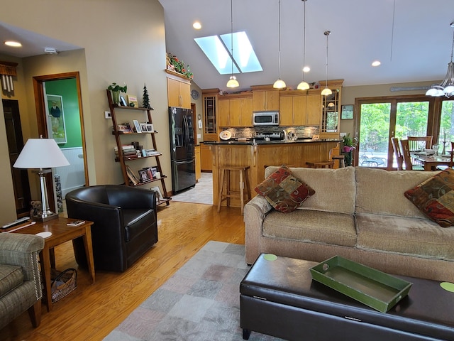 5825 Arawak Pass, Gaylord, MI 49735 - living room featuring a skylight, light wood-style floors, lofted ceiling, and recessed lighting