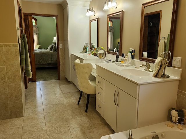 5825 Arawak Pass, Gaylord, MI 49735 - ensuite bathroom with double vanity, a jetted tub, tile patterned floors, and a wainscoted wall