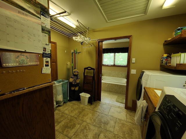 5825 Arawak Pass, Gaylord, MI 49735 - full bath with washer and dryer, a garden tub, vanity, and stone finish flooring