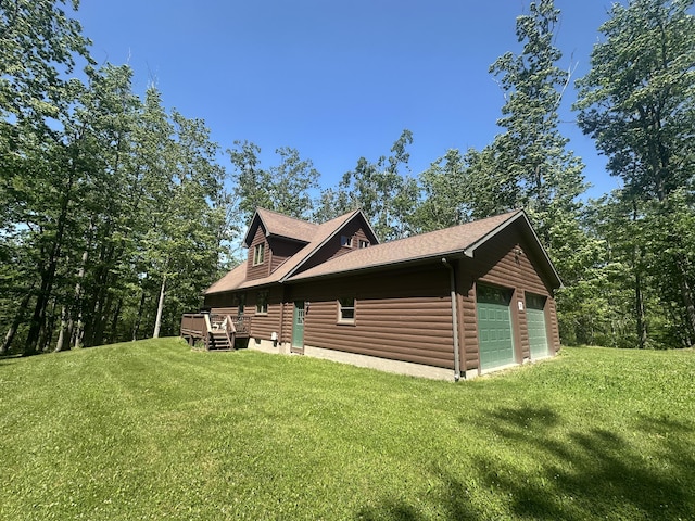 18440 Hardwood Trl, Hillman, MI 49746 - view of side of property with a lawn, a garage, and a deck