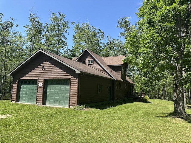 18440 Hardwood Trl, Hillman, MI 49746 - view of side of property featuring a yard and an attached garage