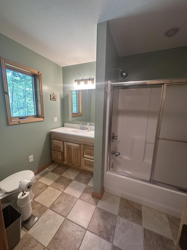 18440 Hardwood Trl, Hillman, MI 49746 - full bathroom featuring vanity, shower / bath combination with glass door, and a textured ceiling