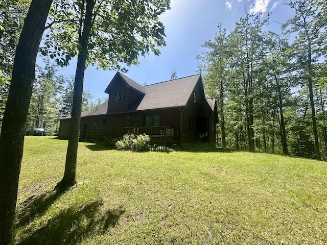 18440 Hardwood Trl, Hillman, MI 49746 - view of property exterior with a yard and a wooden deck