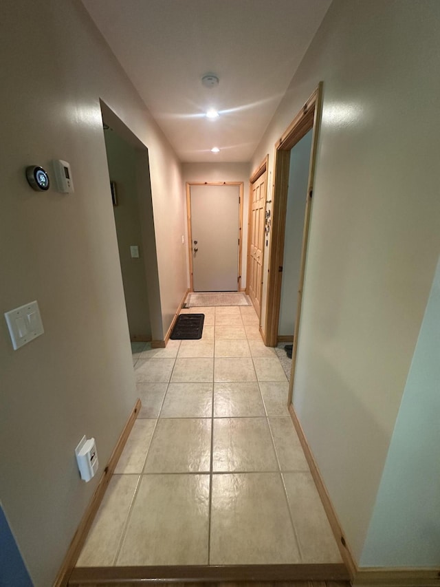 18440 Hardwood Trl, Hillman, MI 49746 - hallway with baseboards and light tile patterned floors