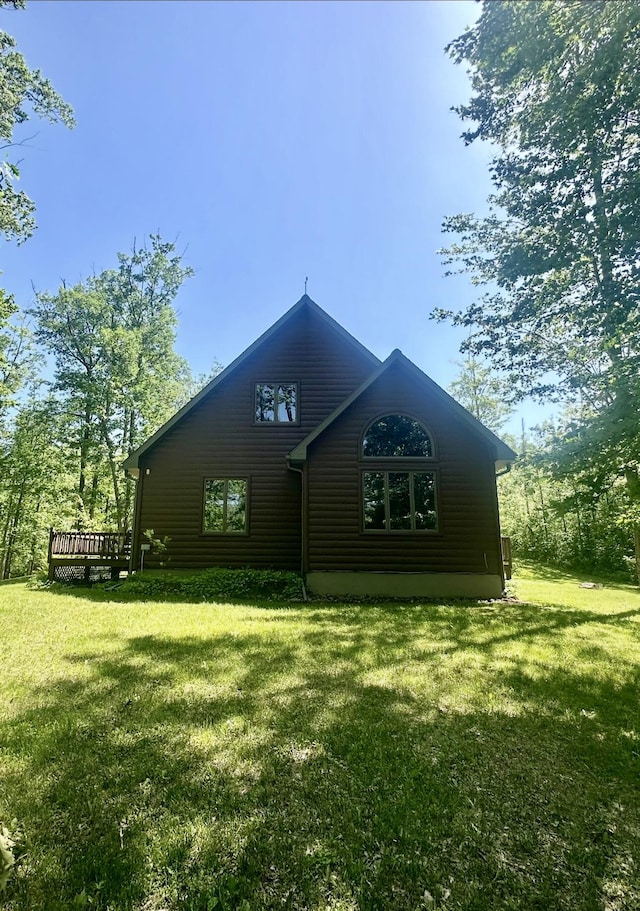 18440 Hardwood Trl, Hillman, MI 49746 - view of front of home with a deck and a front lawn