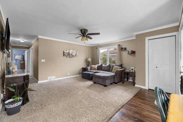 8934 Roberts Rd, Mancelona, MI 49659 - living room with a ceiling fan, ornamental molding, and dark wood-type flooring