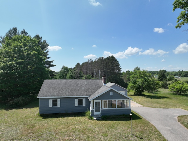 3090 S 37th Rd, Cadillac, MI 49601 - view of front facade with a sunroom and a front yard