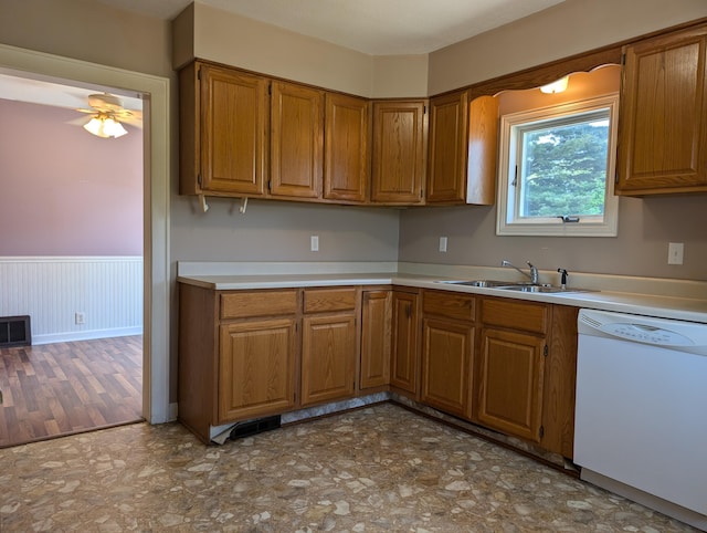 3090 S 37th Rd, Cadillac, MI 49601 - kitchen with dishwasher, brown cabinets, light countertops, a ceiling fan, and a wainscoted wall