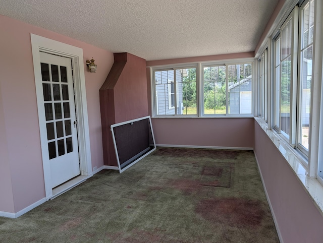3090 S 37th Rd, Cadillac, MI 49601 - unfurnished sunroom featuring a textured ceiling and carpet