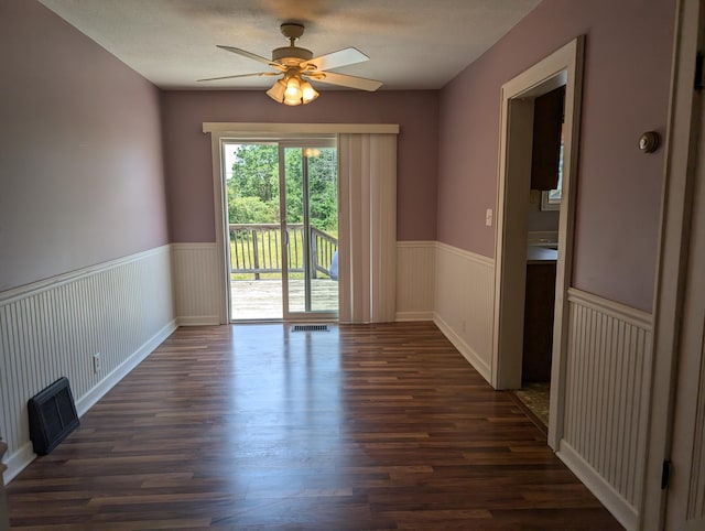 3090 S 37th Rd, Cadillac, MI 49601 - spare room featuring wainscoting, dark wood finished floors, and ceiling fan
