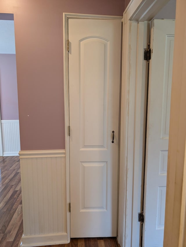 3090 S 37th Rd, Cadillac, MI 49601 - corridor featuring dark wood-type flooring and a wainscoted wall