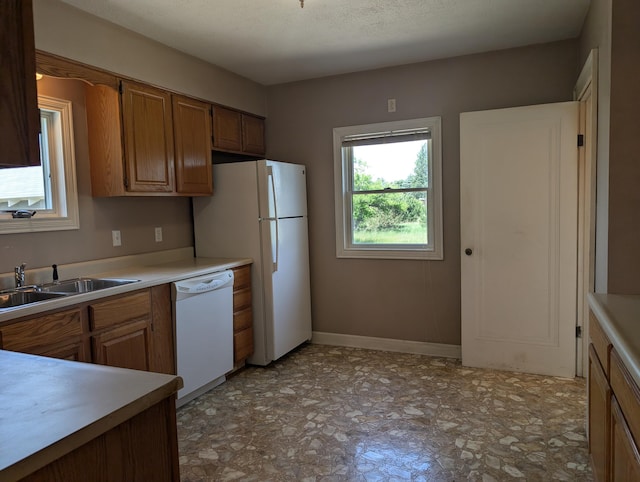 3090 S 37th Rd, Cadillac, MI 49601 - kitchen with white appliances, light countertops, and brown cabinets