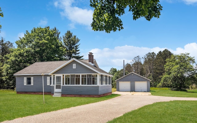 3090 S 37th Rd, Cadillac, MI 49601 - view of front facade featuring a garage, an outbuilding, a chimney, entry steps, and a front yard