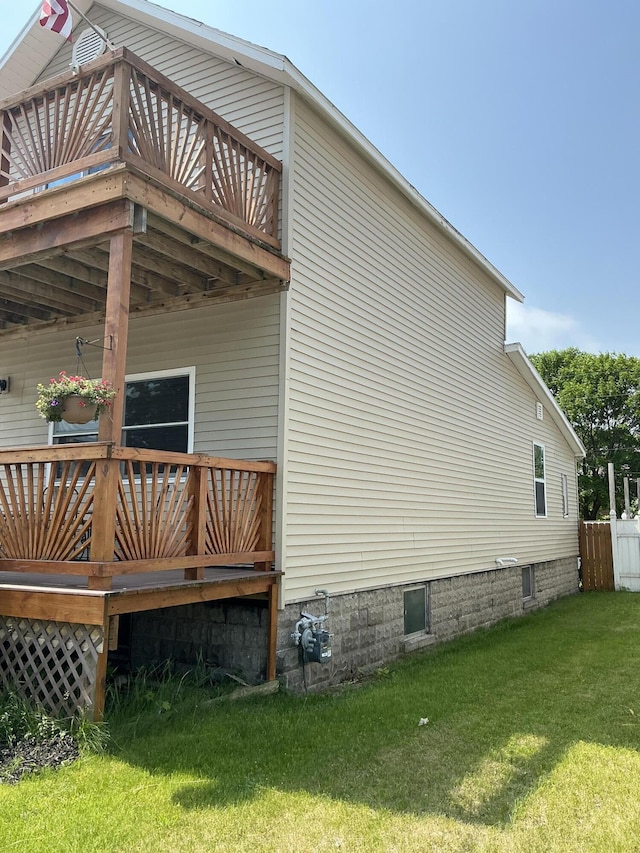 314 Sable St, Alpena, MI 49707 - view of home's exterior with a wooden deck and a lawn