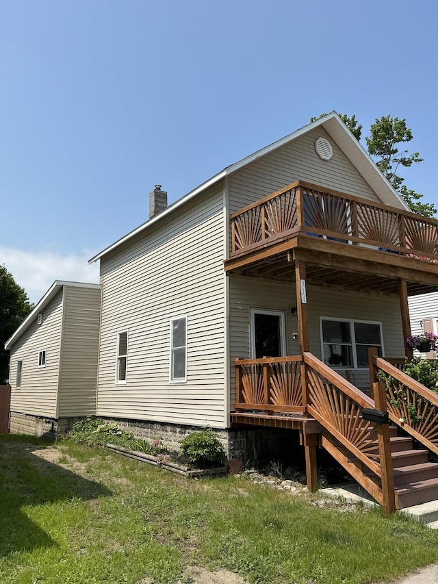 314 Sable St, Alpena, MI 49707 - back of property featuring a chimney and a deck