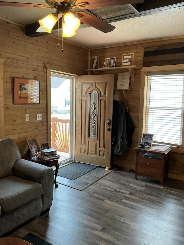314 Sable St, Alpena, MI 49707 - foyer featuring wooden walls, ceiling fan, and wood finished floors