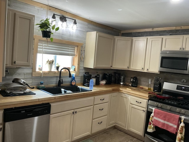 314 Sable St, Alpena, MI 49707 - kitchen featuring stainless steel appliances and decorative backsplash