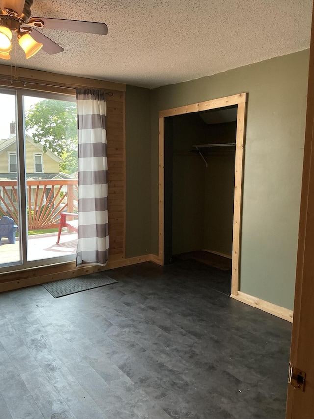 314 Sable St, Alpena, MI 49707 - unfurnished bedroom featuring a textured ceiling, a closet, and a ceiling fan