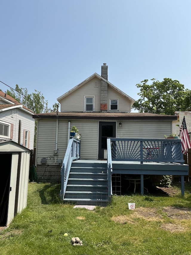 314 Sable St, Alpena, MI 49707 - rear view of property with a storage unit, a deck, a yard, a chimney, and stairs