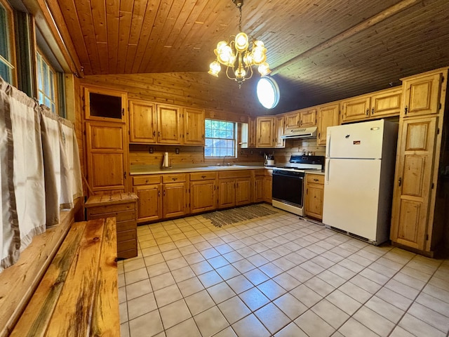 13333 S Black River Rd, Onaway, MI 49765 - kitchen with white appliances, under cabinet range hood, vaulted ceiling, light tile patterned floors, and a chandelier