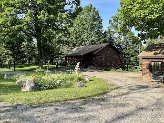 13333 S Black River Rd, Onaway, MI 49765 - view of front of house with log siding and driveway