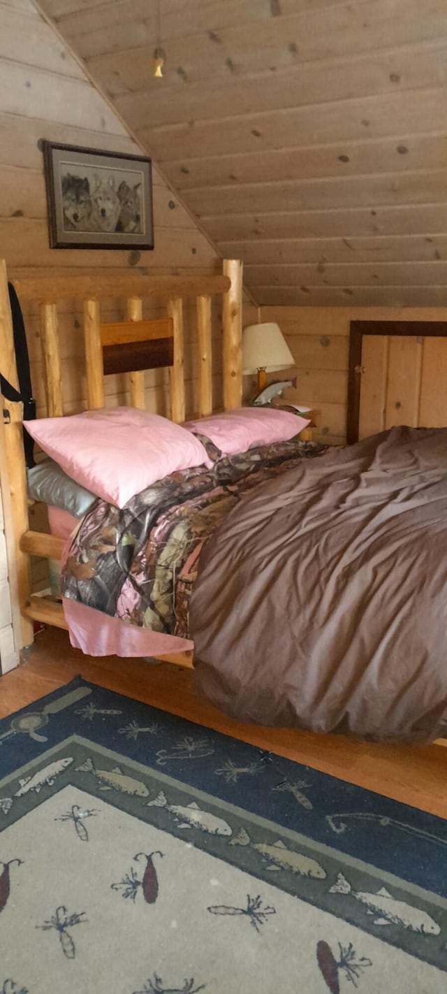 5597 Sunridge Dr, Elmira, MI 49730 - bedroom featuring vaulted ceiling, wood walls, wooden ceiling, and wood finished floors