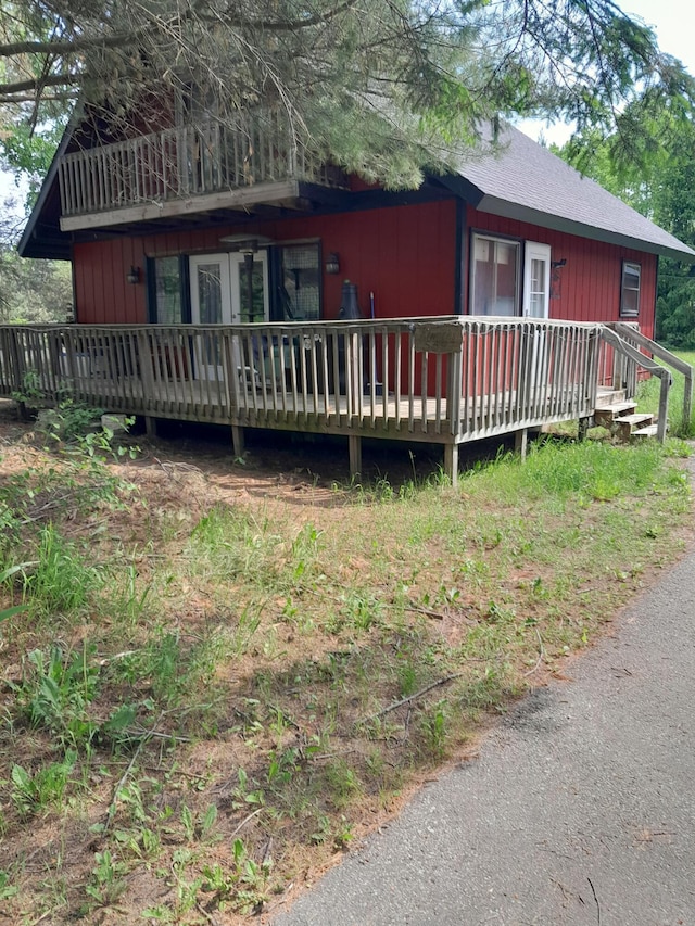 5597 Sunridge Dr, Elmira, MI 49730 - view of front facade featuring a wooden deck