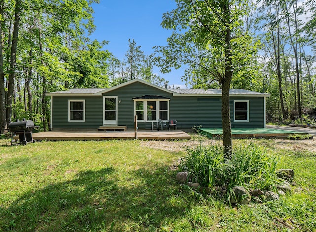 7539 E M-32, Johannesburg, MI 49751 - back of house with a deck, a metal roof, and a yard