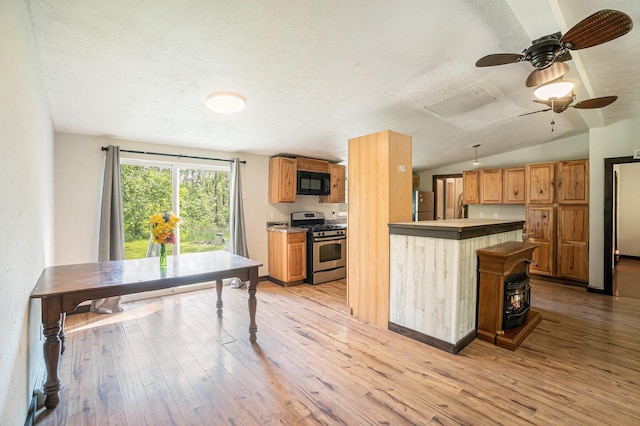 7539 E M-32, Johannesburg, MI 49751 - kitchen featuring appliances with stainless steel finishes, a textured ceiling, a ceiling fan, light wood-style flooring, and lofted ceiling