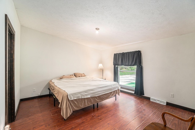 7539 E M-32, Johannesburg, MI 49751 - bedroom with hardwood / wood-style flooring and a textured ceiling