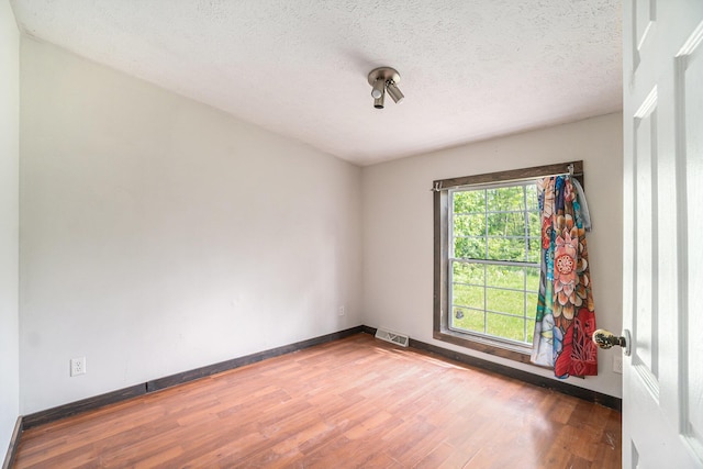 7539 E M-32, Johannesburg, MI 49751 - unfurnished room featuring wood finished floors and a textured ceiling