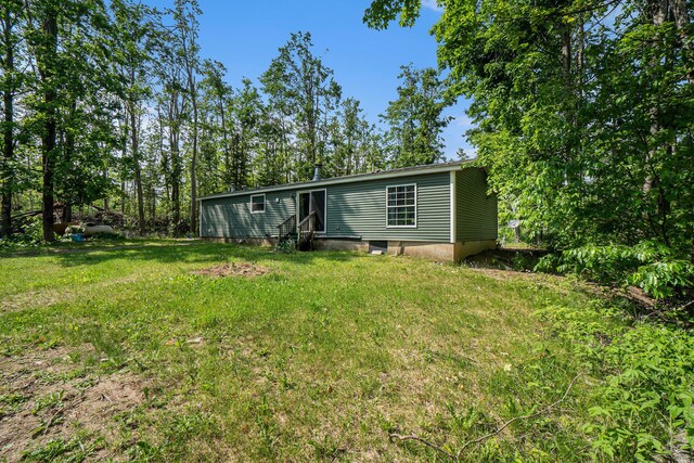 7539 E M-32, Johannesburg, MI 49751 - rear view of property with entry steps and a lawn