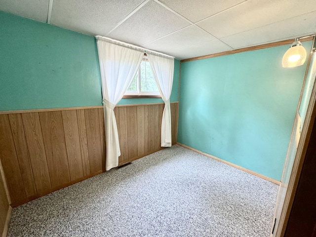 2833 S Horseshoe Trl, Grayling, MI 49738 - carpeted spare room with wood walls, wainscoting, and a drop ceiling