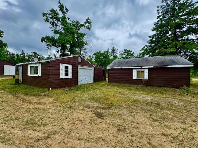 2833 S Horseshoe Trl, Grayling, MI 49738 - view of grassy yard featuring a garage, an outdoor structure, and driveway