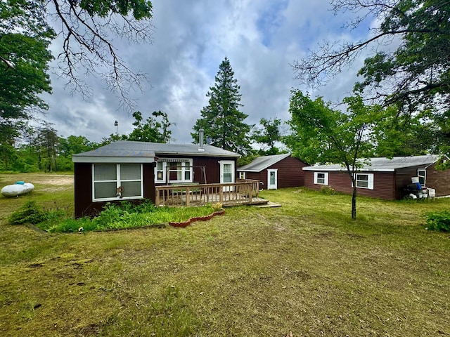 2833 S Horseshoe Trl, Grayling, MI 49738 - rear view of property featuring a wooden deck and a lawn