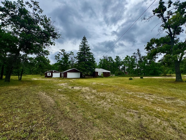 2833 S Horseshoe Trl, Grayling, MI 49738 - view of green lawn with a garage and an outbuilding