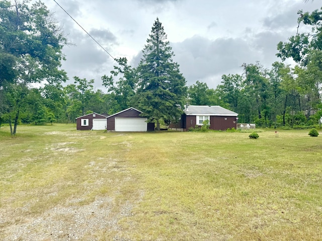 2833 S Horseshoe Trl, Grayling, MI 49738 - view of grassy yard with a detached garage and an outdoor structure