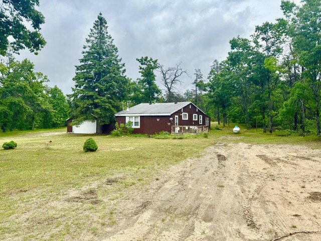 2833 S Horseshoe Trl, Grayling, MI 49738 - view of property exterior with driveway, a yard, and a detached garage